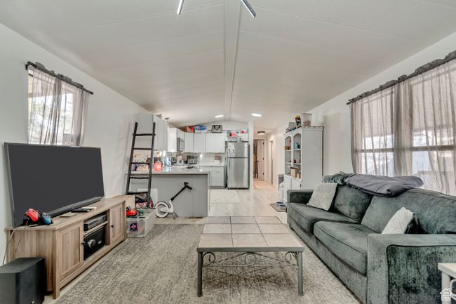 Living area featuring vaulted ceiling and plenty of natural light | Image 8