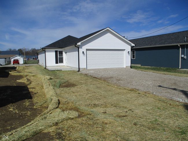 ranch-style house with an attached garage, driveway, and a shingled roof | Image 24