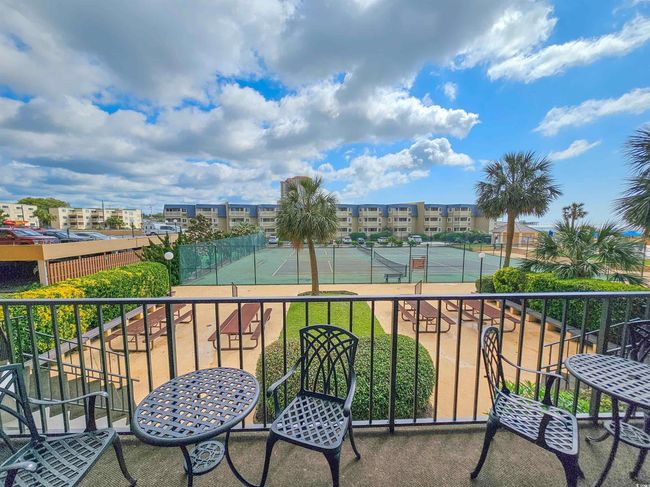 Balcony featuring a tennis court | Image 38