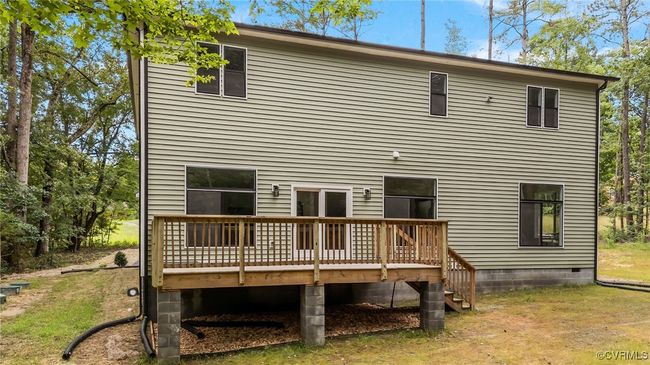 Back of house with a wooden deck | Image 42