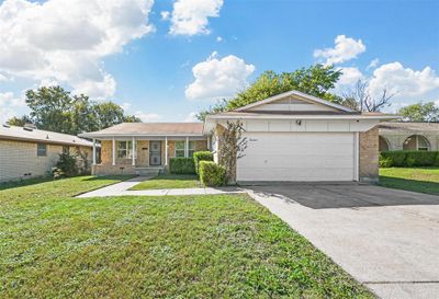 Single story home featuring a garage and a front yard | Image 1