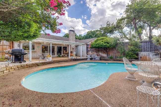 View of pool featuring grilling area, a patio, and a fenced backyard | Image 21