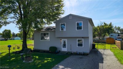 Split level home featuring a front lawn | Image 1