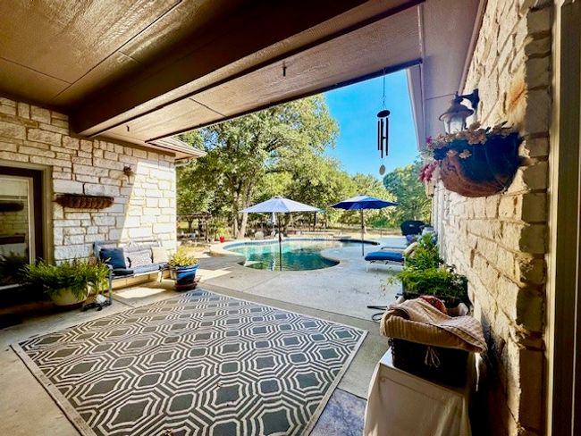 View of patio / terrace featuring an outdoor pool | Image 35
