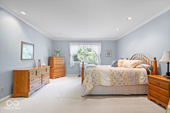 bedroom with light carpet, recessed lighting, and crown molding | Image 23