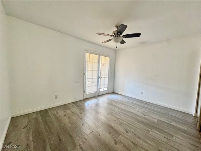 Empty room featuring wood finished floors, baseboards, and a ceiling fan | Image 16