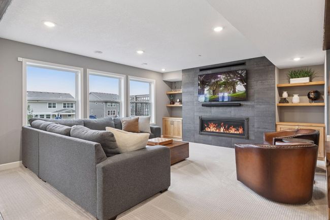Family room with gas fireplace, recessed lights, 3 massive windows and stunning built-ins | Image 30