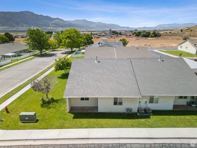 Aerial view of property and surrounding area with a mountain backdrop | Image 29