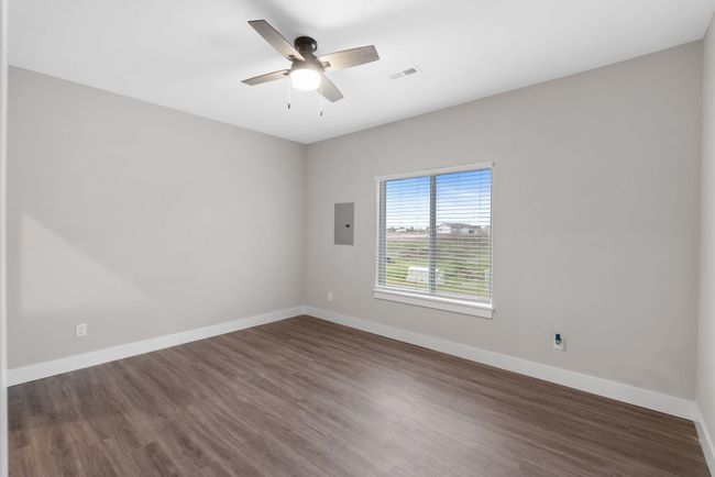 Spare room with electric panel, dark wood-style flooring, a ceiling fan, and baseboards | Image 18