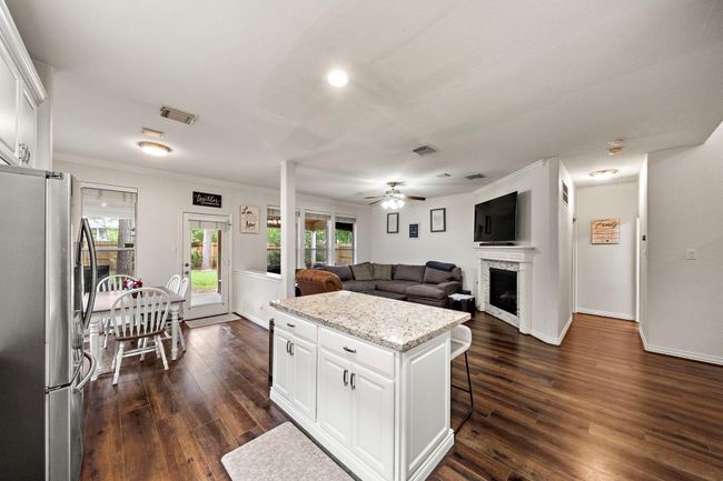 With a open concept Livingroom and kitchen enjoy entertaining your guest while preparing a delicious meal on your kitchen island with a granite counter top. | Image 7