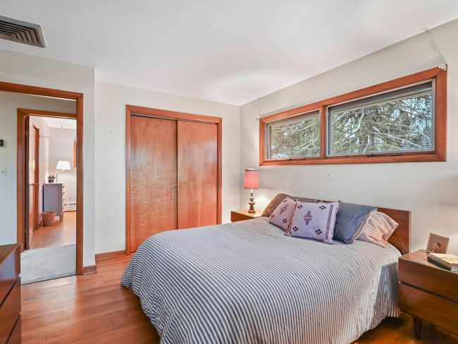 Bedroom with light hardwood / wood-style floors and a baseboard radiator | Image 22
