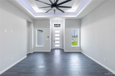 Foyer featuring a raised ceiling and ceiling fan | Image 3