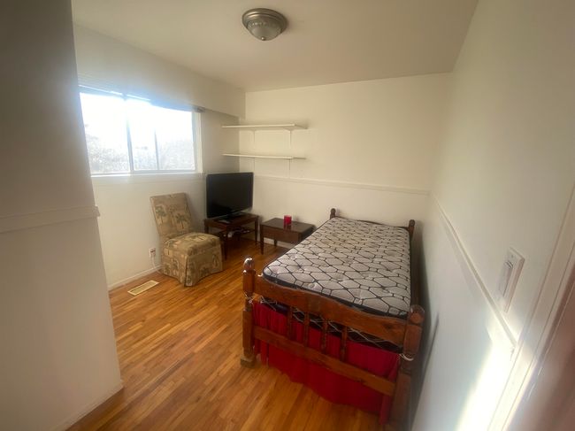 Bedroom featuring wood finished floors and visible vents | Image 4
