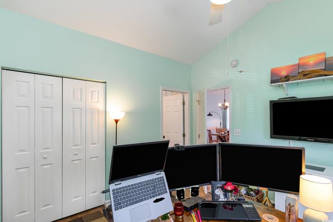 Office area with lofted ceiling and ceiling fan | Image 17