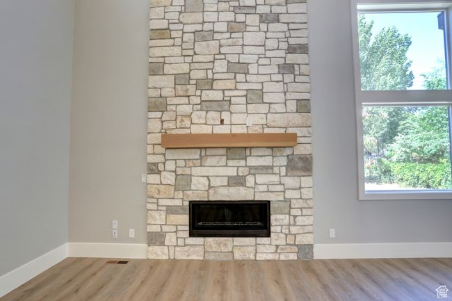 Detailed view of wood finished floors and a fireplace | Image 15