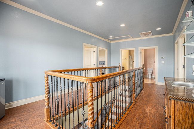 Upstairs, discover a conveniently situated wet bar, perfectly positioned by the French doors that open onto the second deck, making entertaining a breeze. | Image 22