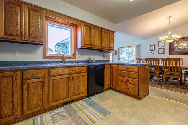 Kitchen features oak cabinets and lots of cabinet space. | Image 4