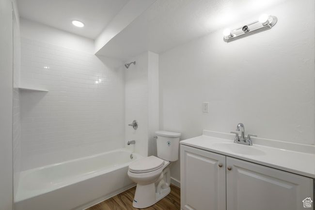 Bathroom with vanity, shower / bathing tub combination, toilet, and wood finished floors | Image 34
