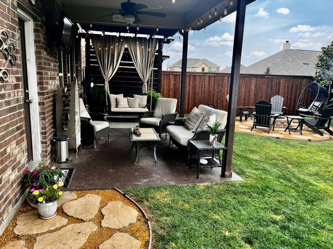 View of patio featuring an outdoor living space, a fenced backyard, and a ceiling fan | Image 30