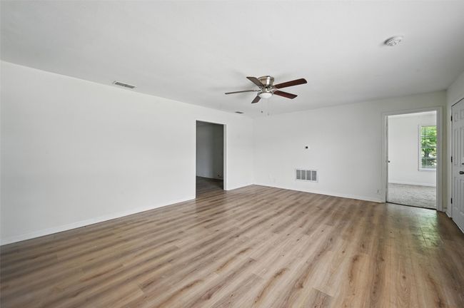 Spare room featuring ceiling fan, wood finished floors, and baseboards | Image 17