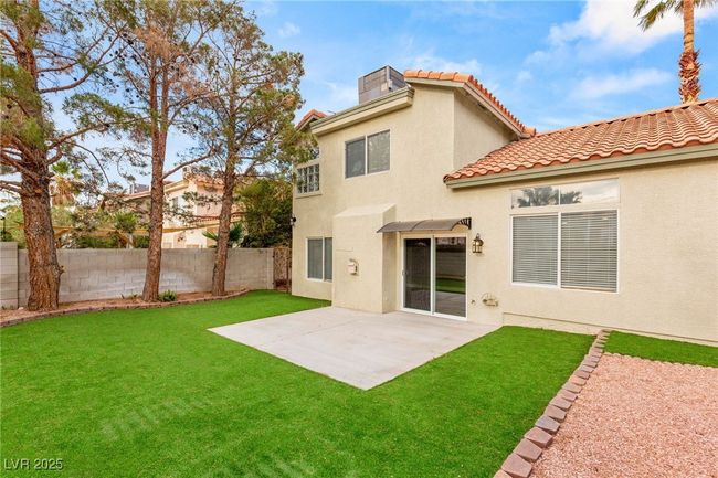Rear view of property featuring stucco siding, fence, a patio area, and a yard | Image 5