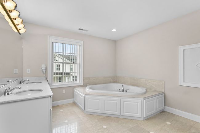 Spacious Primary Bathroom with marble countertops | Image 21