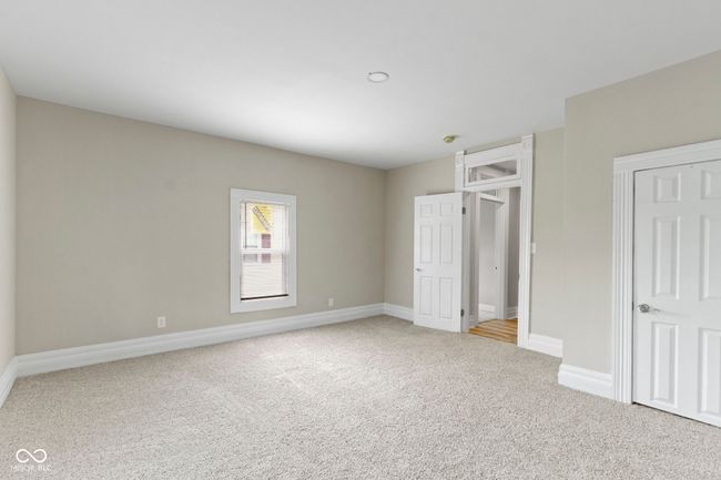 unfurnished bedroom with light colored carpet and baseboards | Image 32