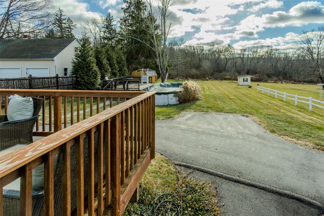 Deck with a yard, a shed, a covered pool, and a patio area | Image 25