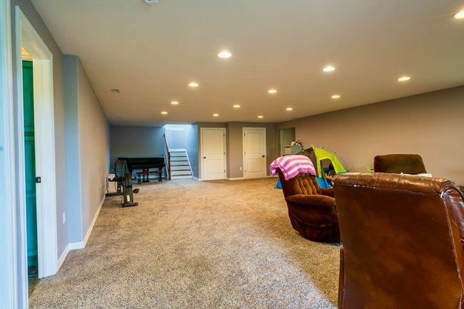 Interior space with stairs, recessed lighting, baseboards, and light carpet | Image 34