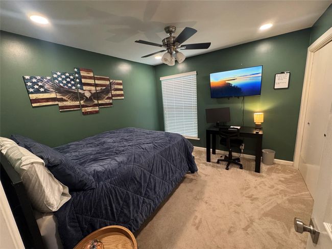 Bedroom with carpet, baseboards, ceiling fan, recessed lighting, and an office area | Image 13