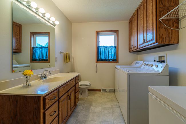 Main floor laundry room features a 1/2 bath. | Image 12