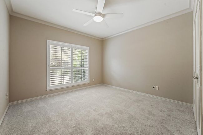 Large Bedroom room featuring ornamental molding, carpet floors, baseboards, and ceiling fan | Image 18