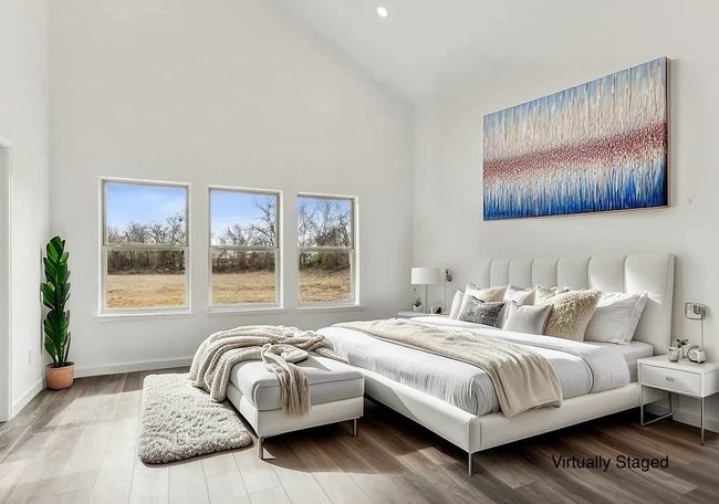 Bedroom featuring high vaulted ceiling, multiple windows, wood finished floors, and recessed lighting | Image 27