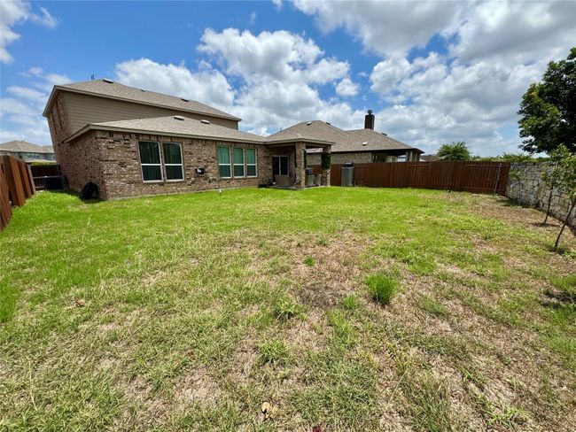 Rear view of house with a fenced backyard and brick siding | Image 33