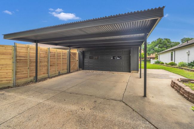 View of parking with a garage and fence | Image 39