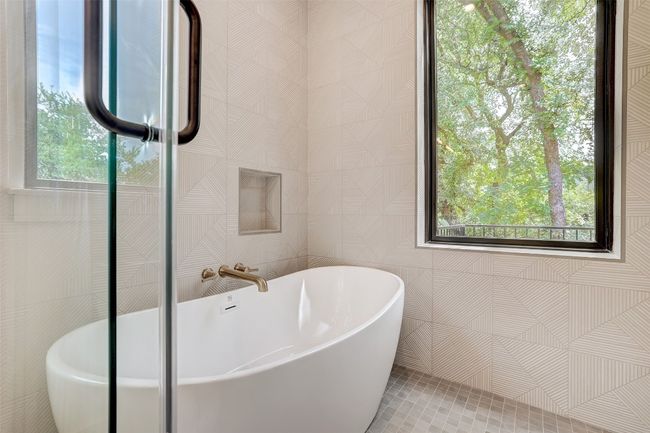 Full bath with a freestanding tub and tile walls | Image 9