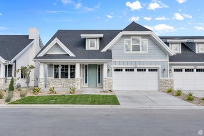 Craftsman house featuring a garage and covered porch | Image 1