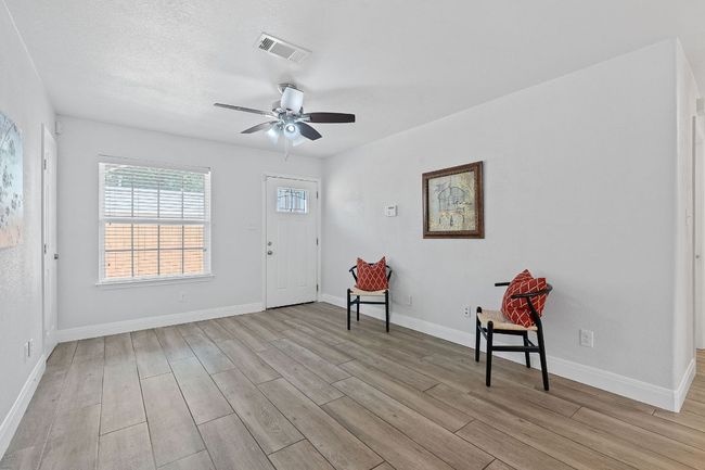 Entrance foyer featuring light wood-style floors and a ceiling fan | Image 9