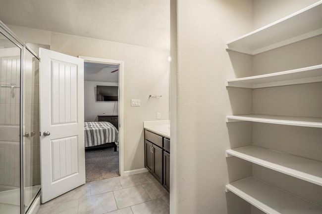 There is a linen closet space in the primary bedroom bathroom. | Image 27