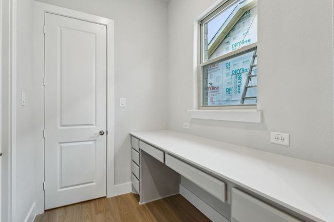 Unfurnished office featuring wood finished floors and built in desk | Image 33