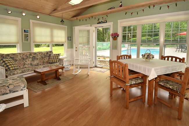 Bright and airy sunroom with cathedral ceilings and exposed beams | Image 18