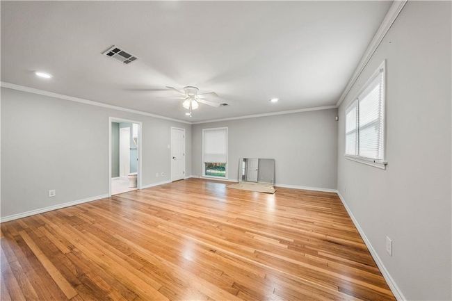 A look into the primary suite after floors were refinished but before Phase II of the project began which gutted the bathroom and enhanced the floor plan. | Image 21