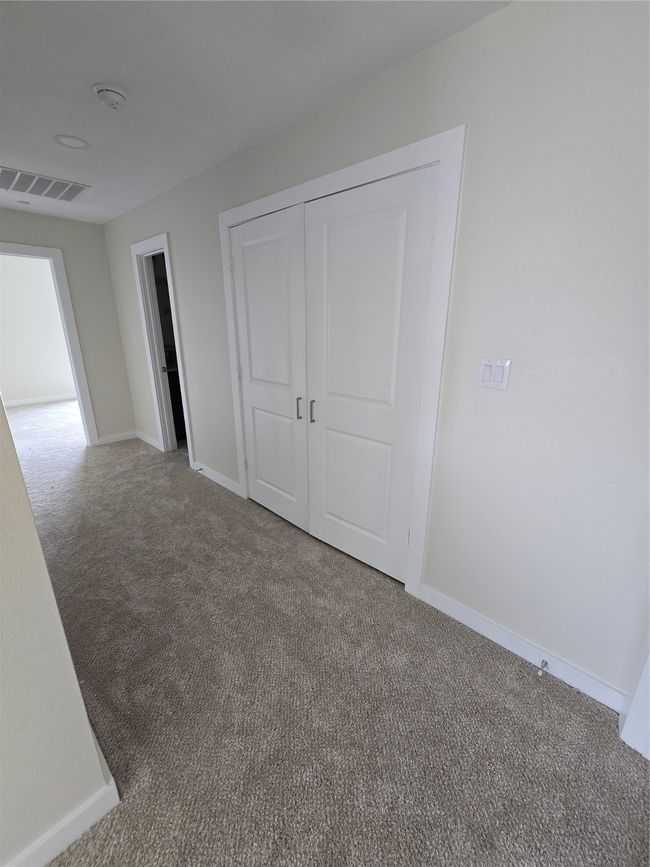 Unfurnished bedroom featuring carpet floors, baseboards, and a closet | Image 19