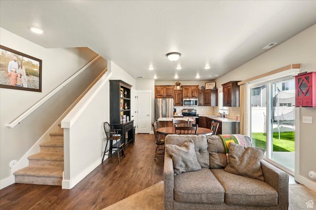Living area featuring stairway, dark wood-style flooring, and recessed lighting | Image 4