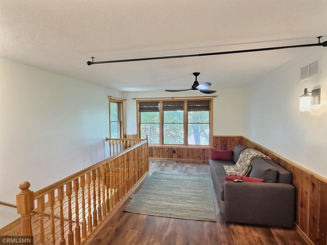 As you enter the upper level of the home, you'll find the den perfect for relaxing and taking in the lake views. | Image 16