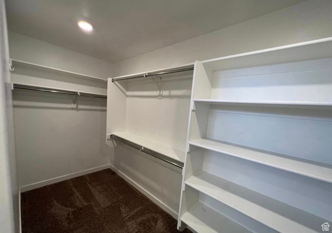 Walk in closet with dark colored carpet | Image 17