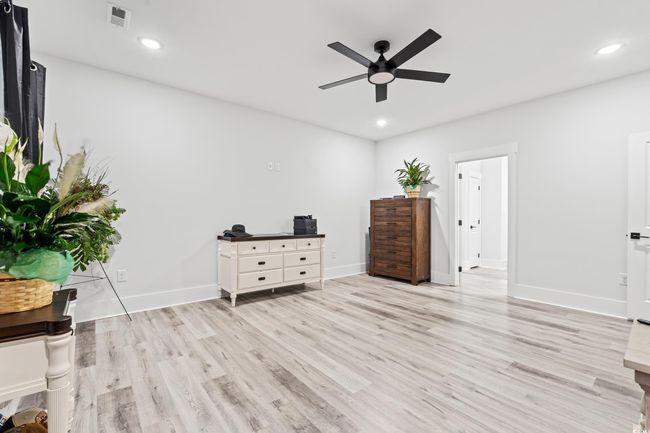 Bedroom featuring light wood-style flooring, recessed lighting, and ceiling fan | Image 10