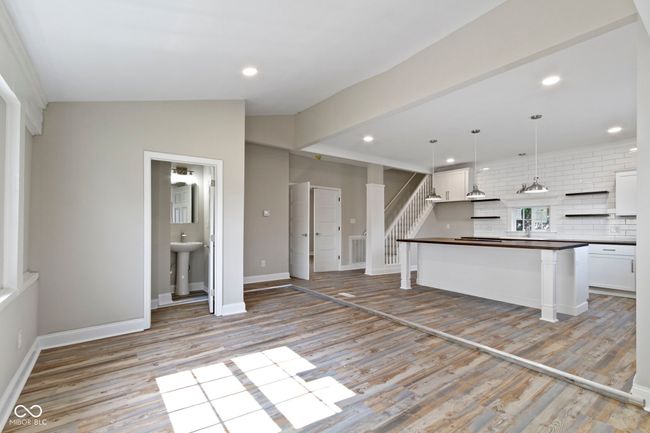 kitchen featuring dark countertops, tasteful backsplash, light wood-style flooring, white cabinets, and recessed lighting | Image 7