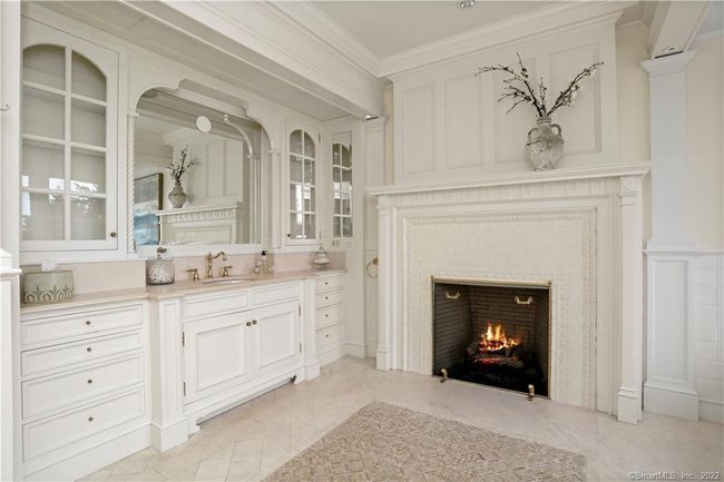 PRIMARY SUITE // Gas fireplace in one of the two luxurious full baths. | Image 19