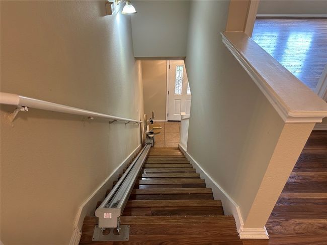 There is a chair to help up the stairs. | Image 18